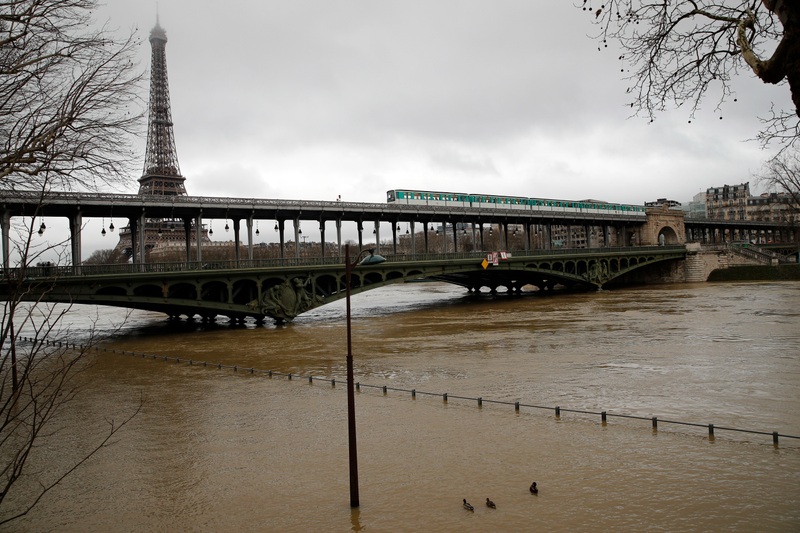 The swelling Seine River inches closer to a bridge in Paris. Photo: AP